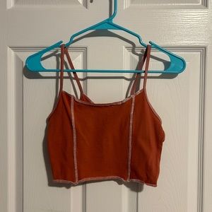 Pacsun red/orange colored top with white patchwork. Never worn. Size Medium.